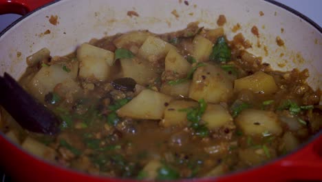 close up shot of papaya curry boiling inside a cast iron pot green and ripe yellow organic fresh papaya pawpaw