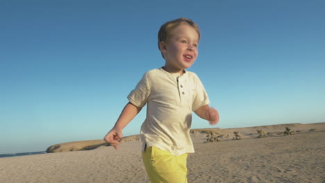 little child running to his father on the beach