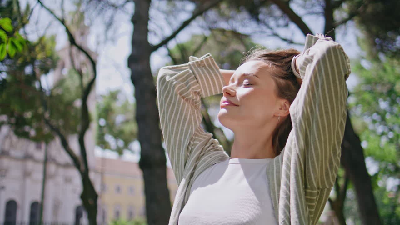 Relaxed woman enjoy sunlight closing eyes at summer park closeup