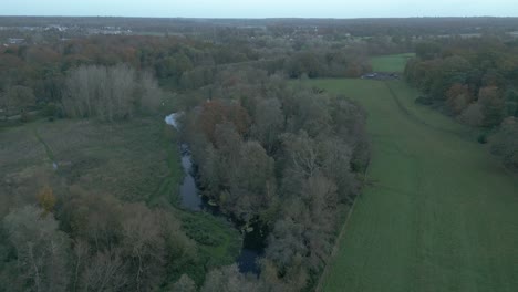 a retreating and slightly tilting aerial drone shot of a quite village in the outskirts of thetford, located in the district of breckland, norfolk county, east of london in united kingdom