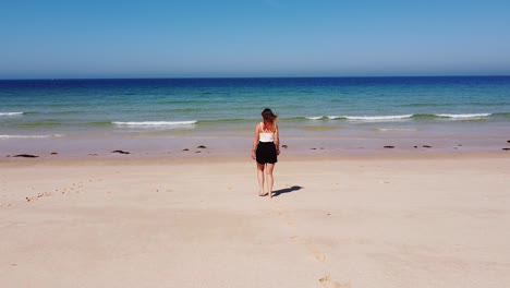 tourist girl walking at the comporta beach, alentejo, west coast of portugal