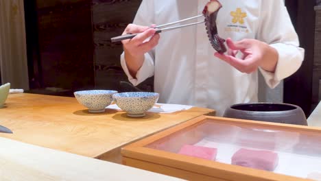 chef skillfully prepares octopus in bangkok restaurant