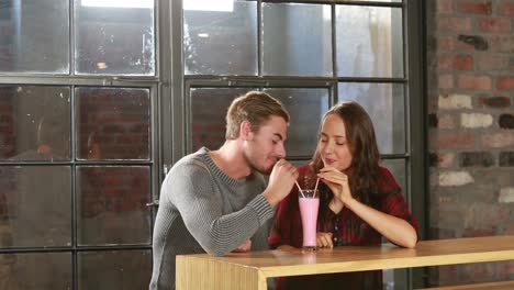 cute couple sipping a fresh drink together