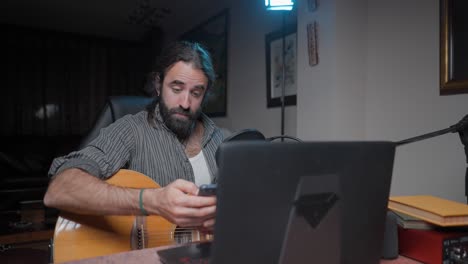 man playing acoustic guitar and streaming music online