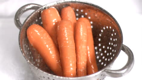 carrots being washed in super slow motion