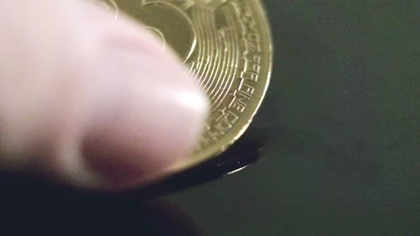 Bitcoin-coin-closeup-fingers-touch-golden-money,-studio-cryptocurrency-trading-value