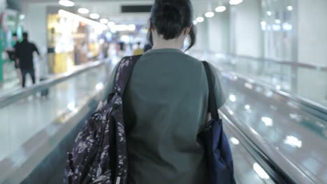 asian woman walking in airport to check in