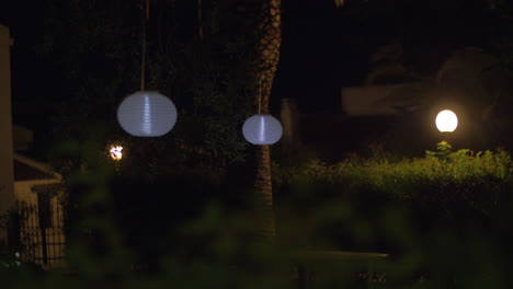 house yard with chinese lanterns at night