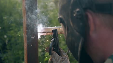 slow motion backside view repairman works at fence building