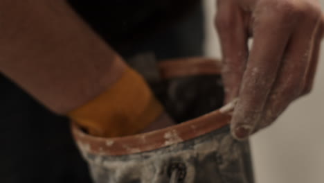 construction worker opening a dirty tool bag