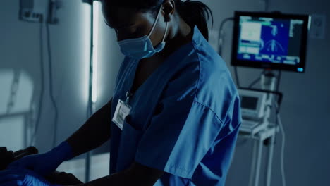 nurse examining a patient in a hospital room at night