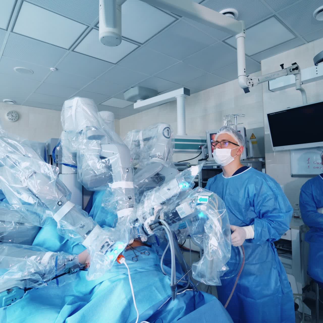 Team of surgeons perform a delicate operation using medical surgical robot. Modern medical equipment. Robotic arm for minimal invasive surgery.