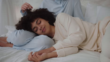 couple in pajamas on bed