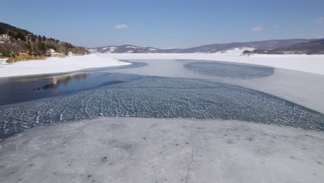 low drone footage capturing a frozen lake's surface in macedonia