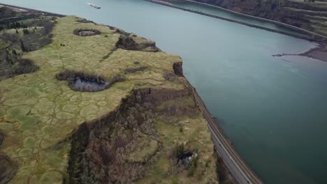 drone captures the beauty of cliffs and river flowing through remote wilderness