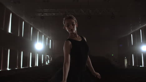 SLOW-MOTION:-Ballerina-dancing-in-Pointe-shoes-on-stage-in-smoke-in-the-dark-light-back-view.-the-camera-moves-on-gimbal