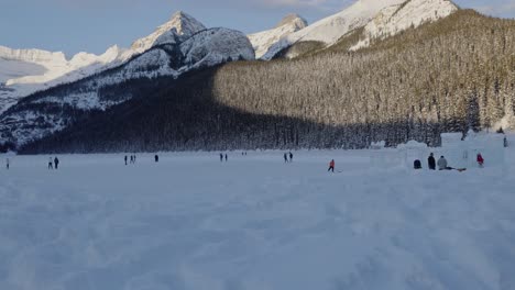 tracking shot people having fun at frozen lake louise