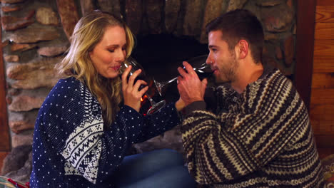 happy couple celebrating christmas together in front the fireplace