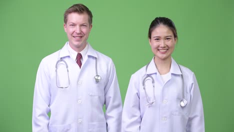happy multi-ethnic couple doctors smiling together