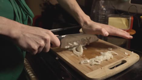 picar cebollas blancas para cocinar una comida en la cocina