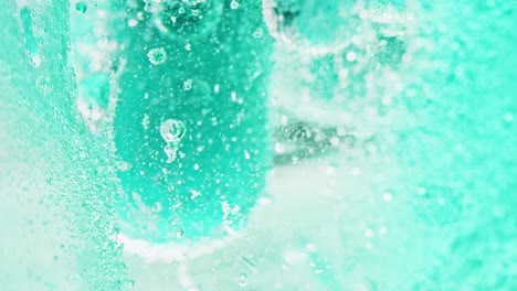 macro shot of big blue bubbles floating and dripping in bright blue water