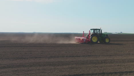 tractor planting crops in a field