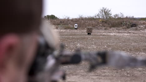 Over-the-shoulder-shot-of-man-shooting-crossbow-in-slow-motion