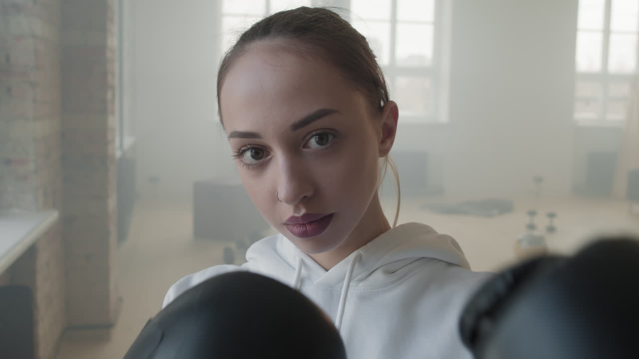 Close-Up Portrait Of Woman In Boxing Gloves