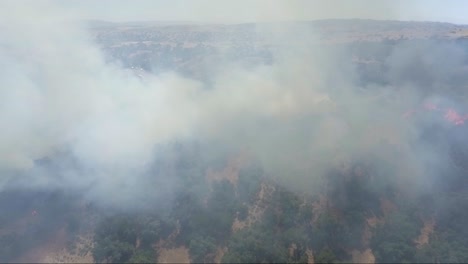 AERIAL---Smoke-filled-screen-shows-air-pollution-from-fire