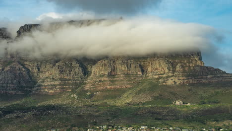 thick clouds over cape town city passing by iconic table mountain in south africa. - timelapse, zoom out