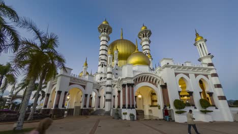 timelapse 4k of people waking at the mosque in kuala kangsar, malaysia during blue hours