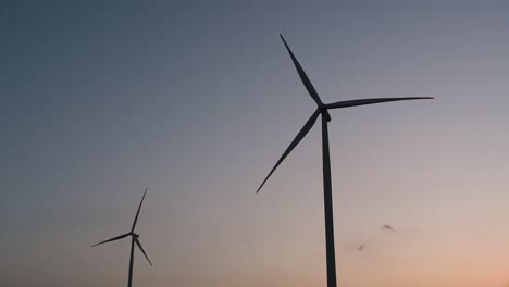 Wind-Turbines-Silhouette-against-the-Blue-sky-during-Sunset,-clean-alternative-energy-in-Thailand-and-mainland-Southeast-Asia