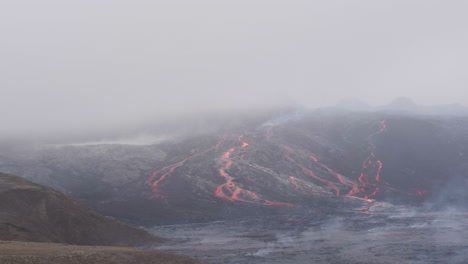 fagradalsfjall volcano in iceland aerial tracking shot of lava flow streaming down hillside