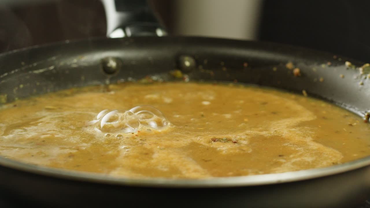 Cooking traditional Indian meal Palak Panir with spinach and cheese close up. Palak paneer is an Indian dish, consisting of paneer in a thick paste made from pureed spinach, Palak paneer is prepared by first boiling and pureeing spinach.