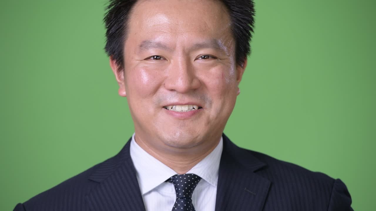 녹색 배경에 성숙한 일본 사업가