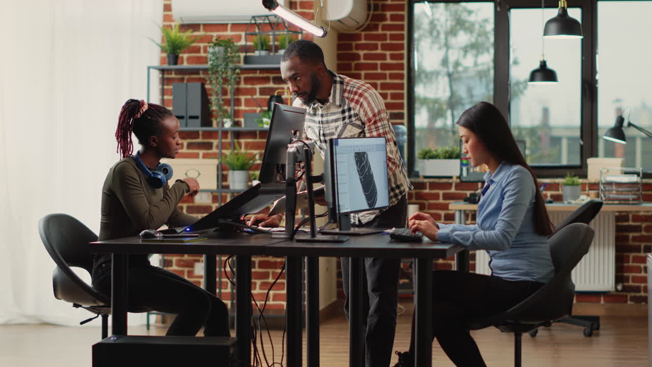 Team of diverse colleagues developing digital software in production studio