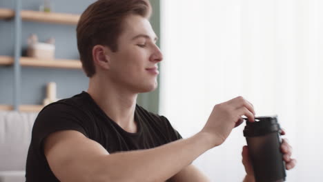 man drinking a beverage at home