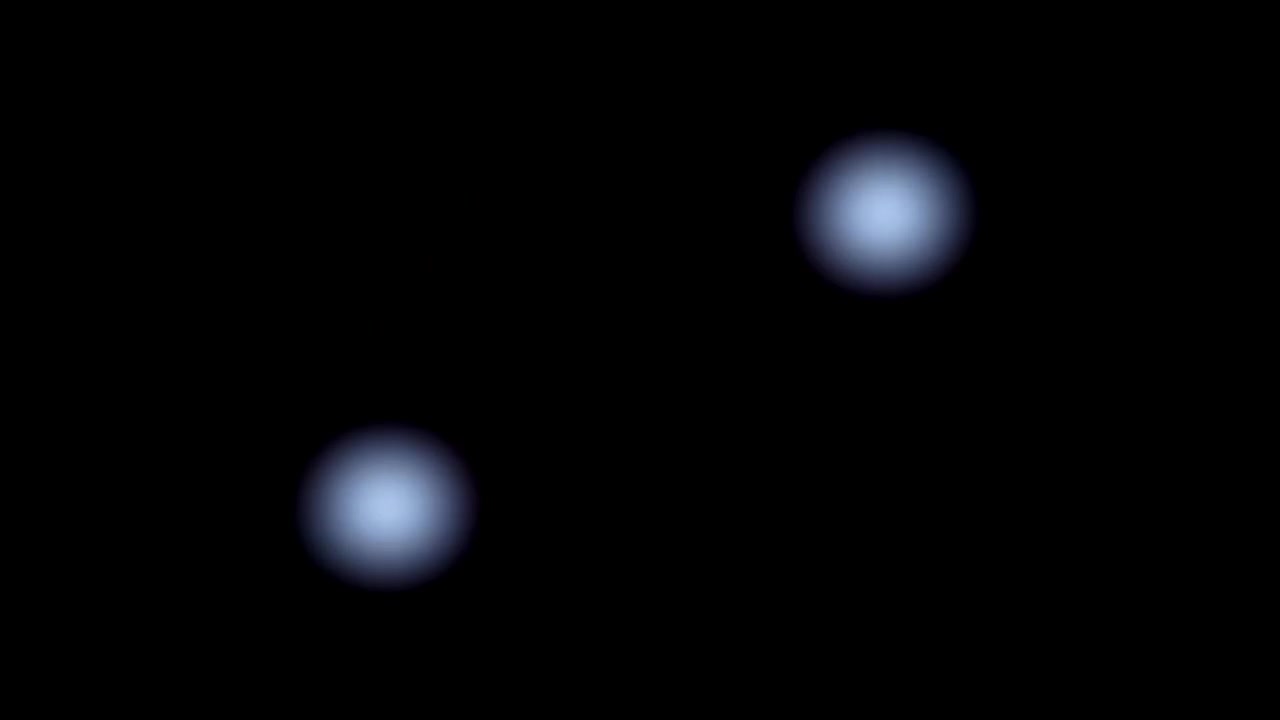 Sfere di luce blu brillante che si fondono e svaniscono su sfondo nero