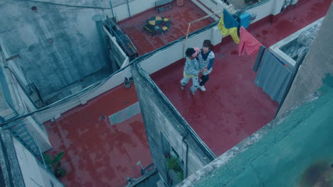 tango couple dancing on urban rooftop of residential building