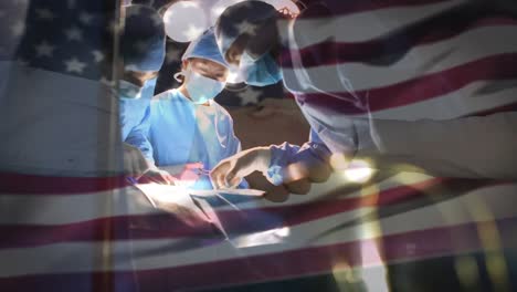 animation of flag of usa waving over surgeons in operating theatre