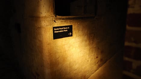 A dimly lit tunnel with directional signage