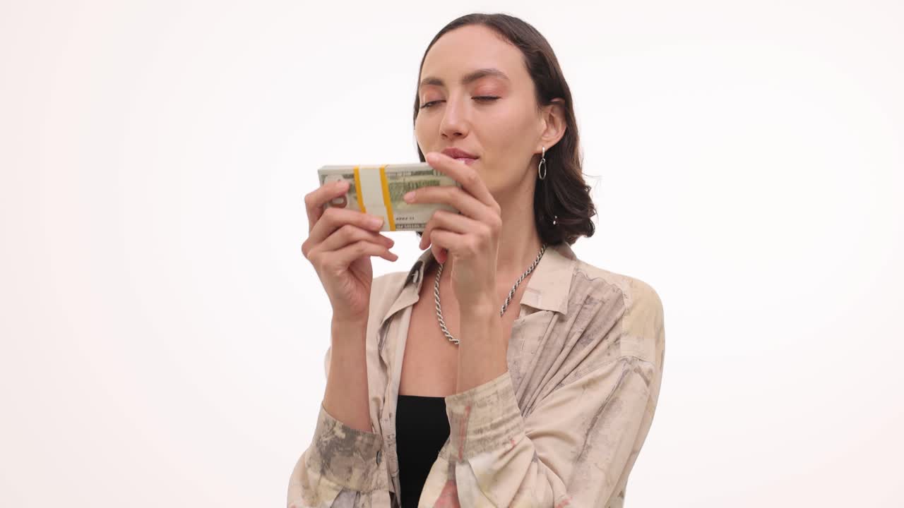 A woman appreciating a stack of cash