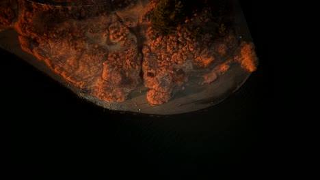 aerial view of a lakeside park at sunset