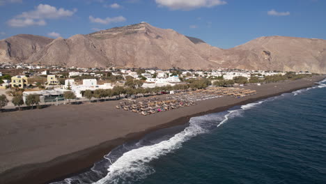 Aerial-View-of-Black-Sandy-Beach,-Coastline-of-Santorini-Island,-Greece