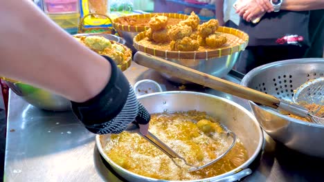 cooking deep fried rice at bangkok's floating market food stall