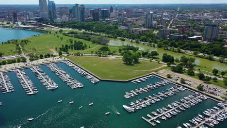 Aerial-view-backwards-over-the-McKinley-Marina-in-sunny-Milwaukee-city,-WI,-USA