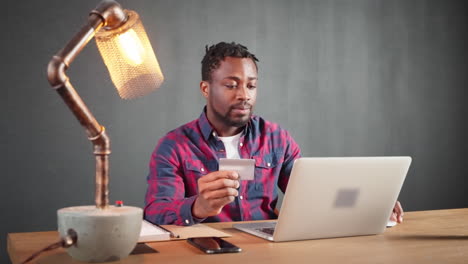 man using laptop and credit card for online shopping