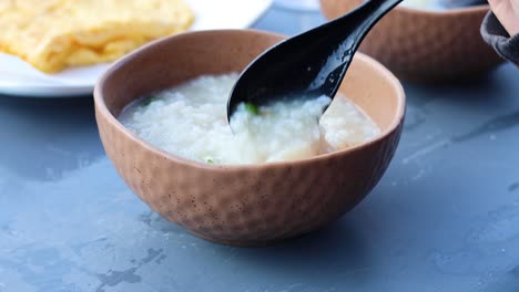 mixing ingredients into porridge in a bowl