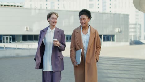 two businesswomen walking and talking