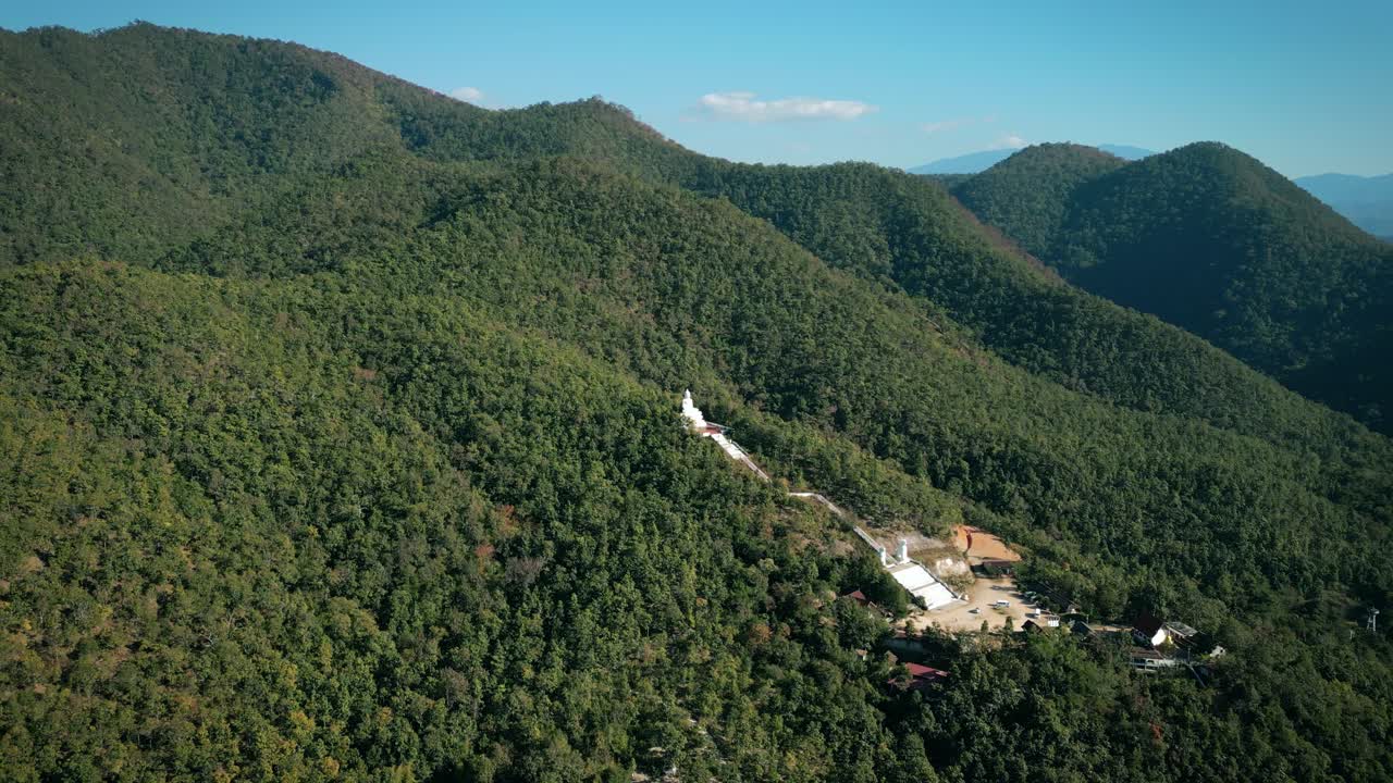 Aerial Scenic Drone Footage of the Big White Buddha in the Mountains of Pai, Thailand on a Sunny Day
